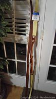 Two recurve bows standing upright against door