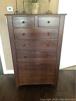 Front view of tall solid wood chest with six drawers