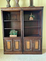 Two matching wood wall units side by side showing shelves and cabinet bases