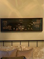 Full view of the entire shadow box wall hanging showing its size, frame style, and content layout.