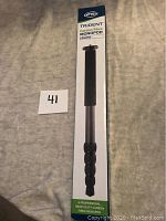 Boxed Trident Carbon Fibre Monopod by Optex showing packaging front with product image and branding.