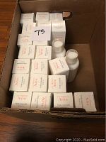 Photo of multiple boxed and unboxed Avene beauty products in a cardboard box, labeled with number 75.