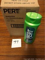 Box of Pert Plus Moisturizing 2in1 shampoo and conditioner bottles and one bottle displayed in front of the box.