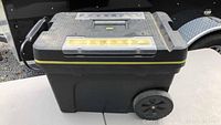 Black Stanley rolling toolbox with handle, wheels, and lock.