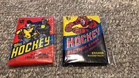 Two unopened wax packs of Topps hockey trading cards from 1978 and 1981, showing front packaging designs.