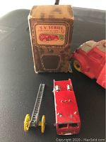 Benbros T.V. Series No. 9 fire engine with ladder and original box, red and yellow painted die-cast metal toy showing play wear