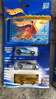 2003 Hot Wheels 35th Anniversary collector's guide gift pack with three exclusive die-cast cars in blue, silver, and gold colors.