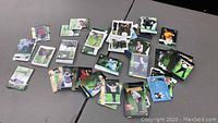 Photo showing multiple stacks and spread of golf trading cards featuring Tiger Woods, with visible cards laid out mainly showing Woods' golf poses.