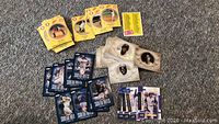 Photo showing a spread of various baseball cards including yellow circular-cornered cards, blue-backed baseball cards, and sepia-tone Upper Deck cards