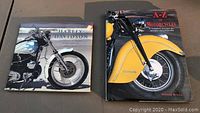 Two motorcycle books placed side by side, Harley Davidson and A-Z of Motorcycles.