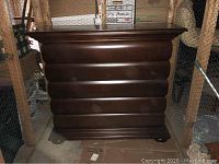Full front view of the dresser showing bombé curved profile and top surface