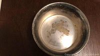 Top view of silver bowl showing tarnished interior surface with visible wear marks.