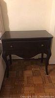 Solid mahogany nightstand table with a single drawer, curved legs, and dark polished finish shown from the front.