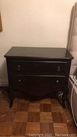 Full view of the solid mahogany night table showing front, curved legs, and ring pull hardware on drawers.