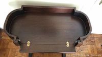 Top view of removable tray top showing brass hinges and scalloped edges
