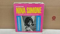 Photo showing Nina Simone's 'The Second Album' with bright pink and blue cover.