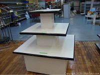 Full view of three-tier display stand with casters