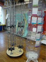 Wide angle of both spinning card racks side by side, showing metal wire holders and clear plastic pockets