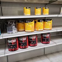 Overview of three small Para Premium, three large Para Premium and three SICO Evolution cans on metal shelf