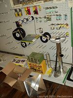Overall pegboard display with spools of marine cable, packaged connectors, fuses, grommets and loose items on shelf