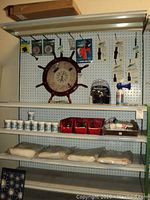 Wide view of pegboard shelving with marine and painting items