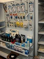 Pegboard display of packaged pumps, wrenches, treatments, vents, filters