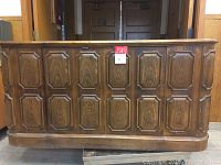Front view of the cabinet showing the decorative veneered wooden doors with detailed panel design.