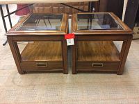 Pair of vintage wooden end tables placed side by side showing top and front view with glass tops and drawer handles.