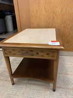Front and angled view of the wooden vintage nightstand showing stone top, drawer, and open shelf below