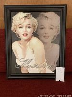Wooden framed dual image of Marilyn Monroe with one colored and one faded profile portrait.