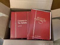 Box with 5 books showing red hardcover bindings with titles like 'Christmas in The Netherla' and 'Christmas in Washington D.C.'