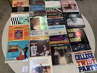 Photo showing 25+ vinyl album covers arranged in rows on a surface, featuring titles including Music Man Soundtrack, Glenn Miller, Leroy Anderson, Henry Mancini, Harry Belafonte and more.