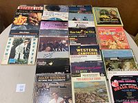 Photo showing a collection of over 25 vinyl albums from artists including Brenda Lee, Steve Martin, Chet Atkins, Bobby Vinton, Tex Ritter, and various soundtracks and country albums arranged on a flat surface.