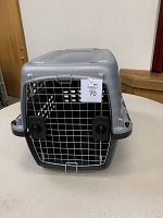Front view of the Petmate animal crate with door closed showing metal wire door with locking knobs.