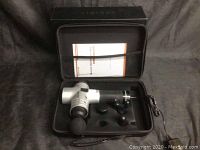 Massage gun in carrying case with four different massage heads and charger cable