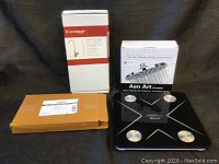 Items featured: boxed faucet and accessory items, boxed Aen Art shower head, black glass digital bathroom scale with silver accents