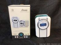 Photo of Christie HD Radio and box showing front view with digital clock display and rotary dial control.