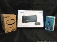 Front view of the boxed items including Velex 500-watt wireless amplifier, Seven Sparta cup extender box, and diesel fuel pump box with instructions.