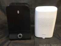 Photo showing a black dehumidifier with rotary control knob and a white humidifier with perforated sides and brand name Aitalk visible on front.