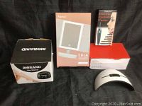 Photo of all items together showing boxes and the nail lamp device outside its box