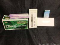 Overview of all items arranged on black background showing all boxes and products in their packaging.