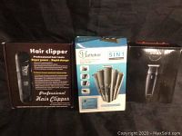 Original packaging boxes for three hair clippers showing branding and features.