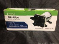 Box of the Pentair Shurflo Revolution 4008 Fresh Water Pump with visible branding and model info.