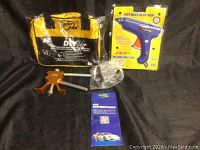 Full lot of DIY paintless dent repair kit items arranged on dark background including the glue gun, dent puller, manual, and carry bag.