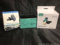 Lot of three vehicular phone mounts in original boxes, including Scaling magnetic car mount, gravity auto clamping mount, and Scaling extension-type non-slip mount.