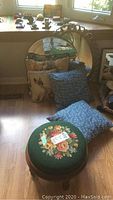 Overall view showing two mirrors, four cushions of different designs, and a floral upholstered stool