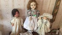 Photo of three dolls standing together showing sizes and outfits