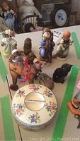 Overview of assorted Hummel and vintage small figurines including animal figurines and ceramic box