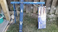 Mastercraft collapsible metal sawhorses shown outdoors against wooden fence.