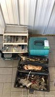 Overall view of three plastic toolboxes with assorted hardware and tools inside